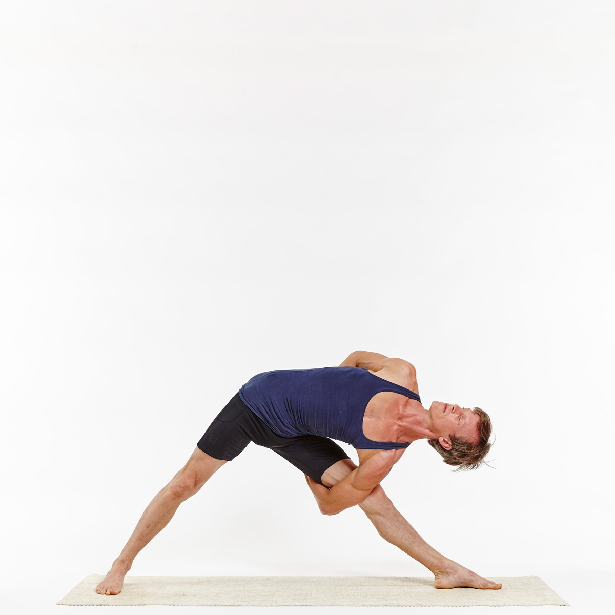 Man in triangle pose young practicing yoga Vector Image