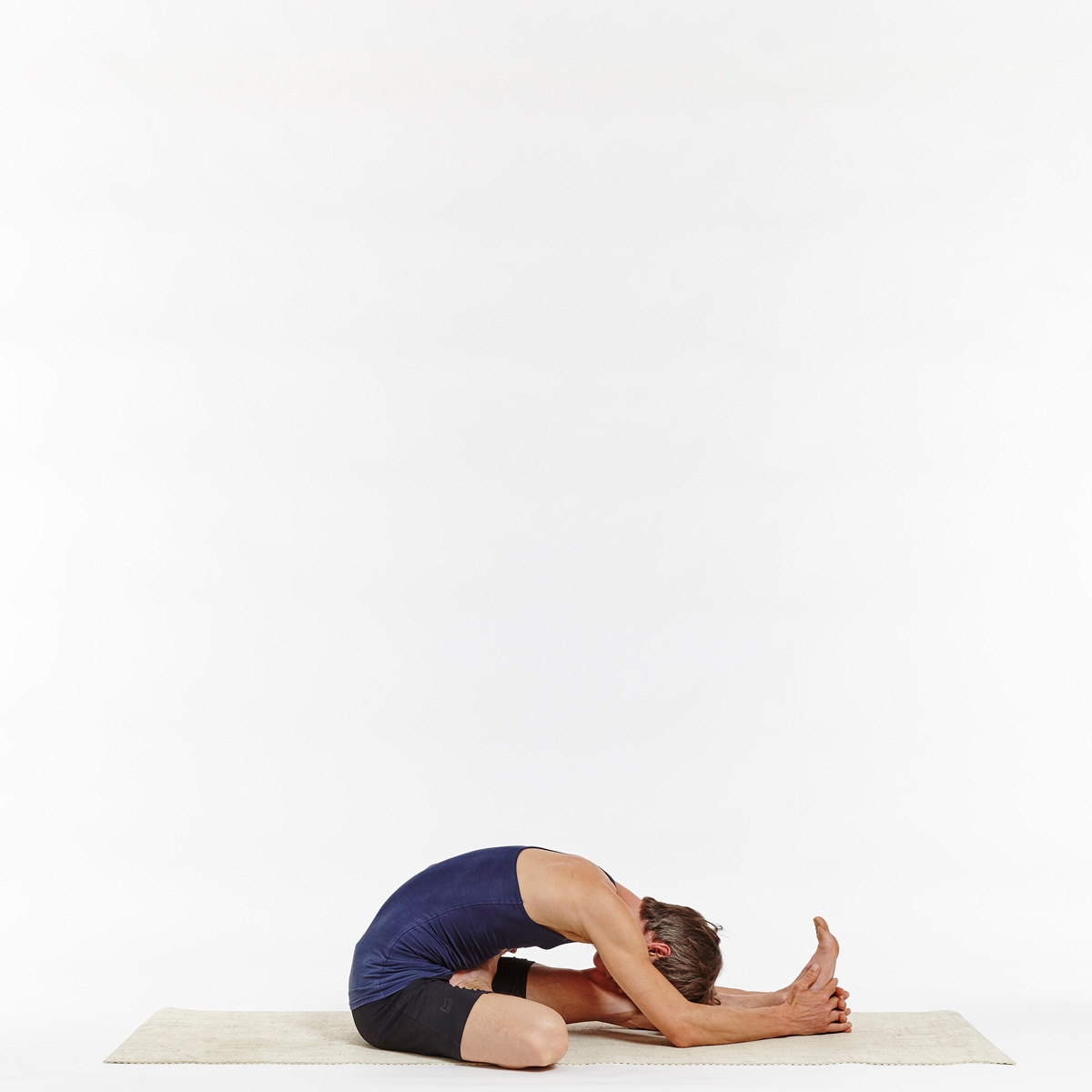 Premium Photo | Flexible young woman performing oneleg balance exercise  doing half bound lotus standing forward fold pose indoors