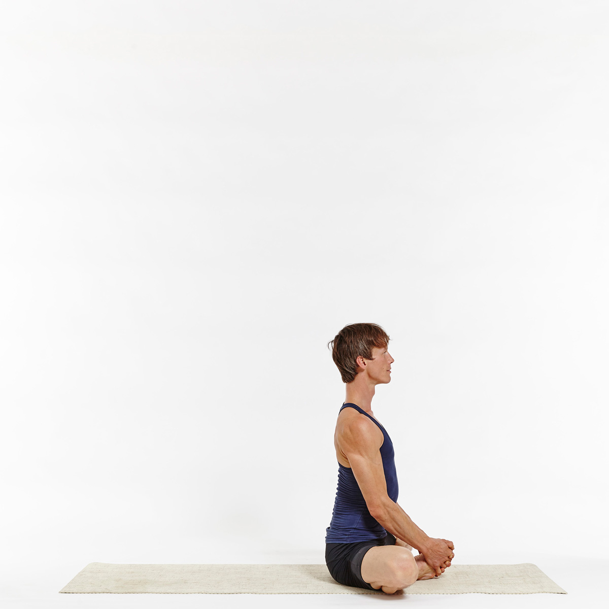 Calm african american woman doing yoga exercise, sitting in baddha  konasana, bound angle or butterfly pose Stock Photo | Adobe Stock